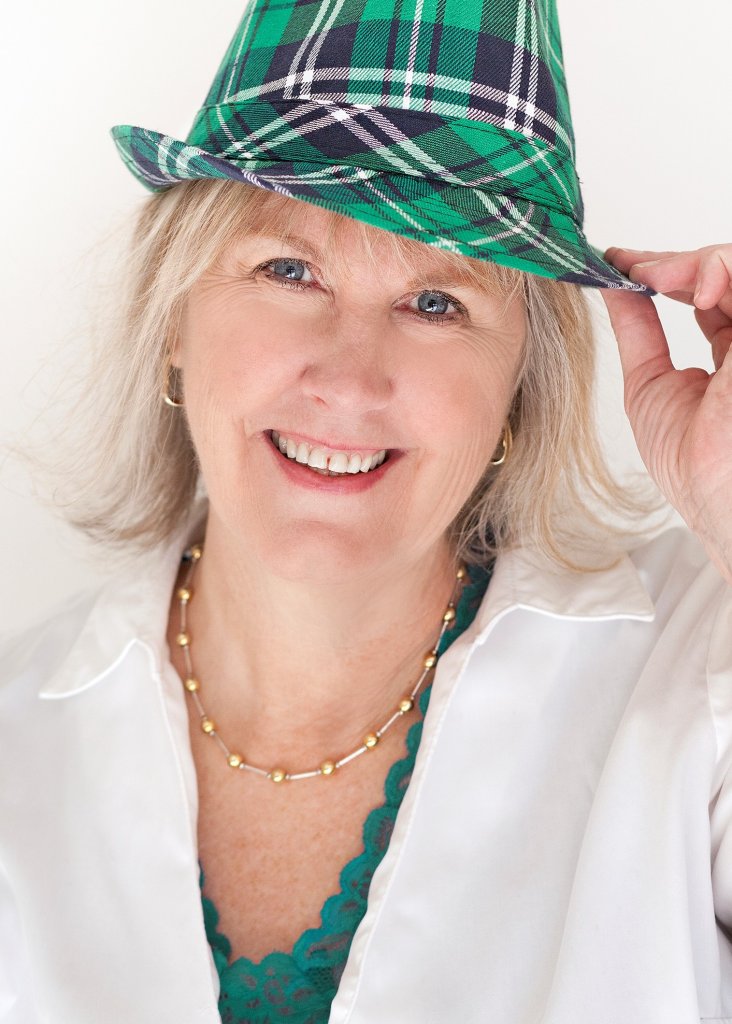 Meet Donna Reed. An interview with Donna Reed, REALTOR® at Keller Williams Southern Arizona. Donna serves as the Chairperson of the Culture Committee on the Keller Williams Southern Arizona Agent Leadership Council (ALC) for 2023. Donna has blonde hair, is wearing a white shirt and a green plaid hat, facing forward and is smiling.