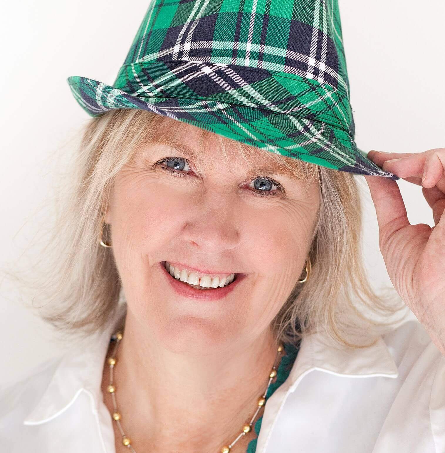 Meet Donna Reed. An interview with Donna Reed, REALTOR® at Keller Williams Southern Arizona. Donna serves as the Chairperson of the Culture Committee on the Keller Williams Southern Arizona Agent Leadership Council (ALC) for 2023. Donna has blonde hair, is wearing a white shirt and a green plaid hat, facing forward and is smiling.